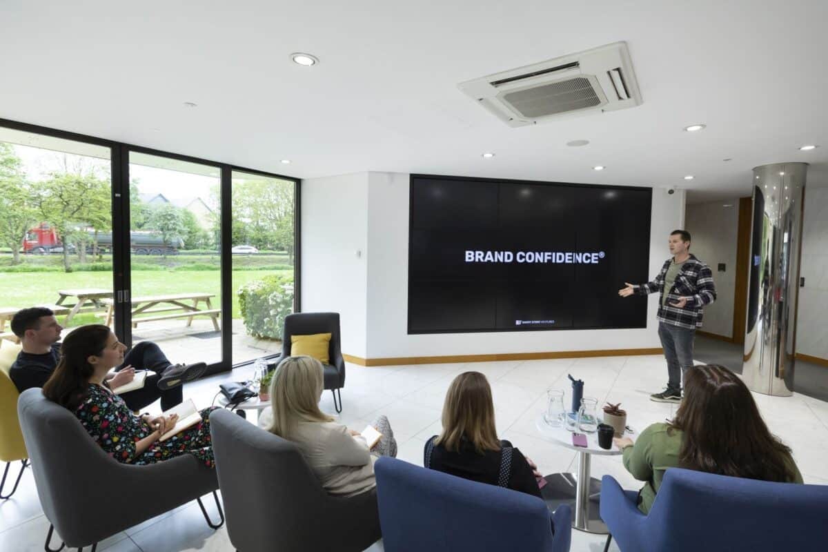 A presentation in the breakout lounge with the garden behind
