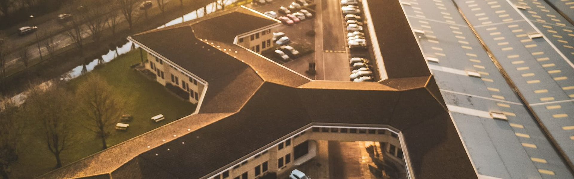 The zigzag rooftops of Watermoor Point at sunset, from above