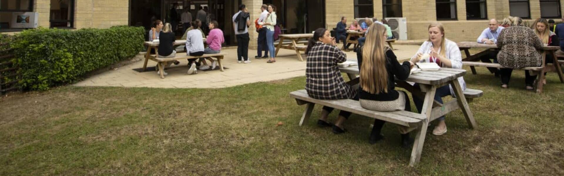 Members lunching at picnic tables outside the Watermoor Point offices