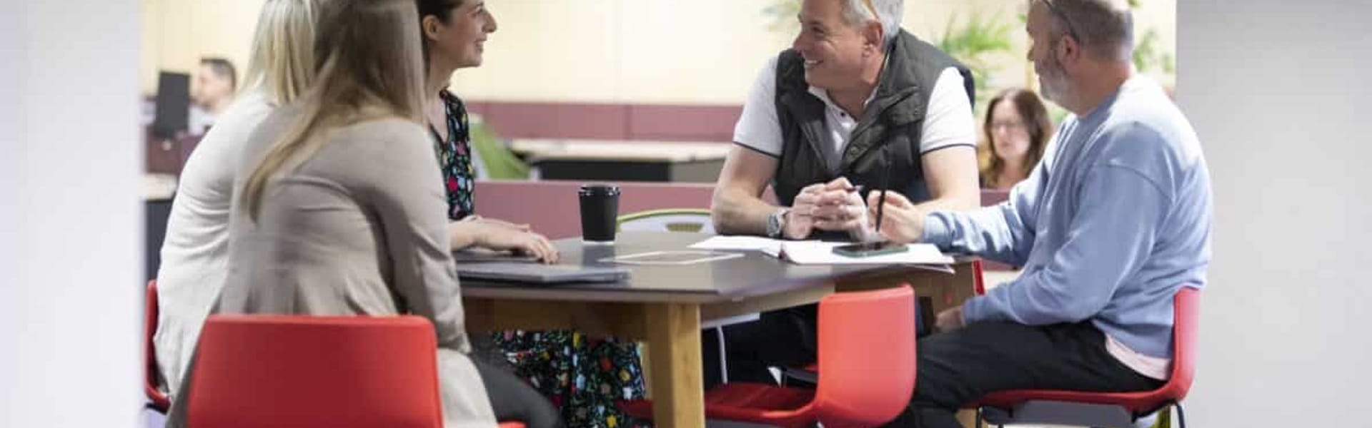 Members chatting around a high table at Watermoor Point